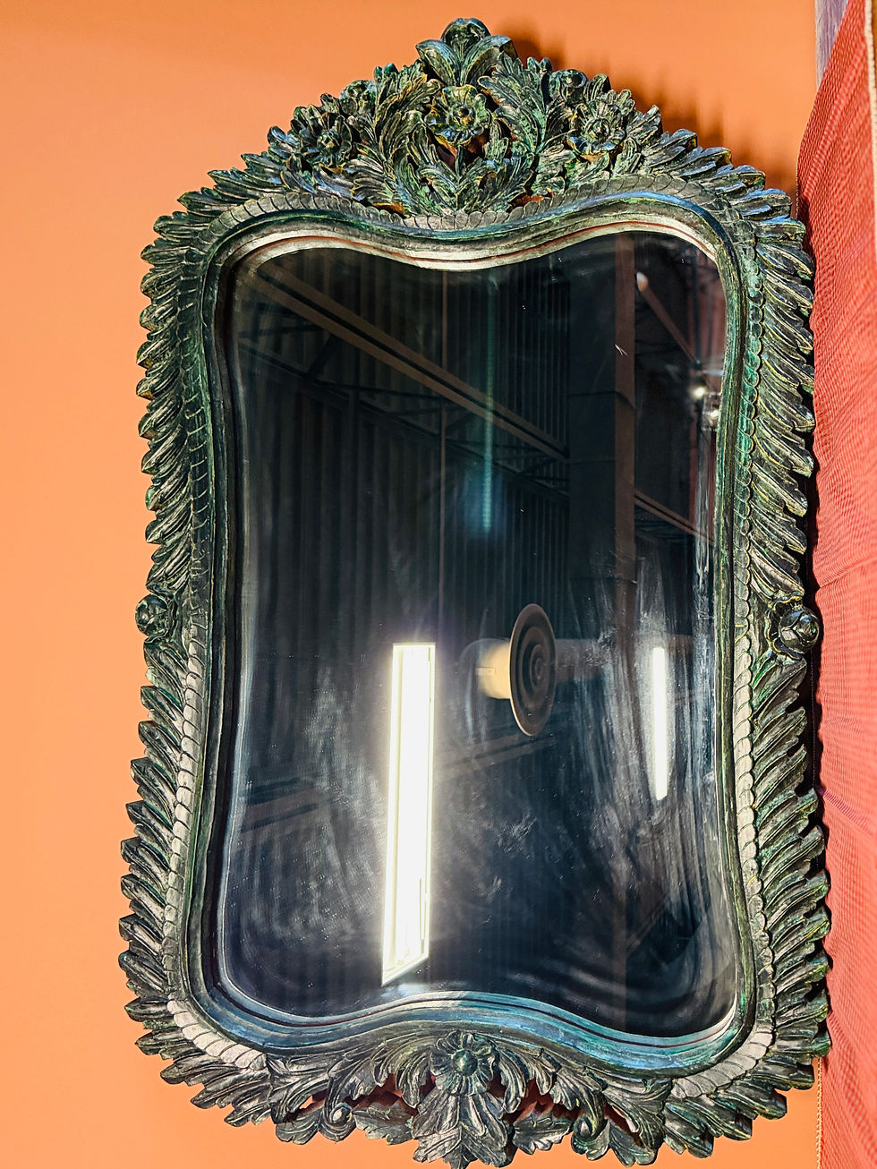Large rectangular mirror with an intricately carved, dark green or verdigris-finished wooden frame