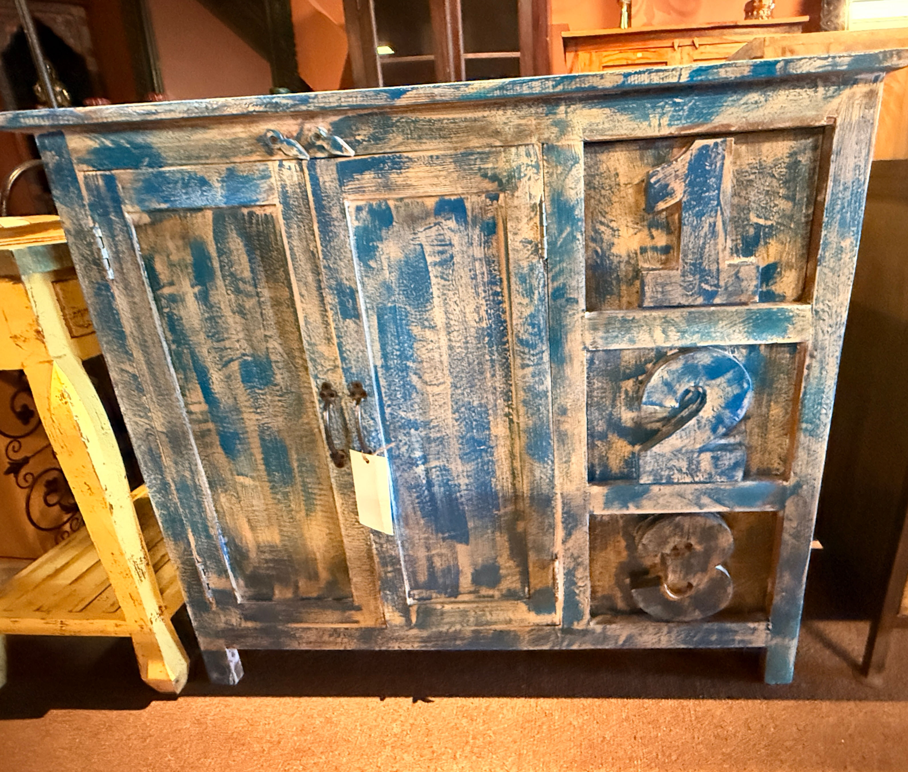 Vintage blue wooden sideboard with distressed finish and numbered drawers for rustic home storage