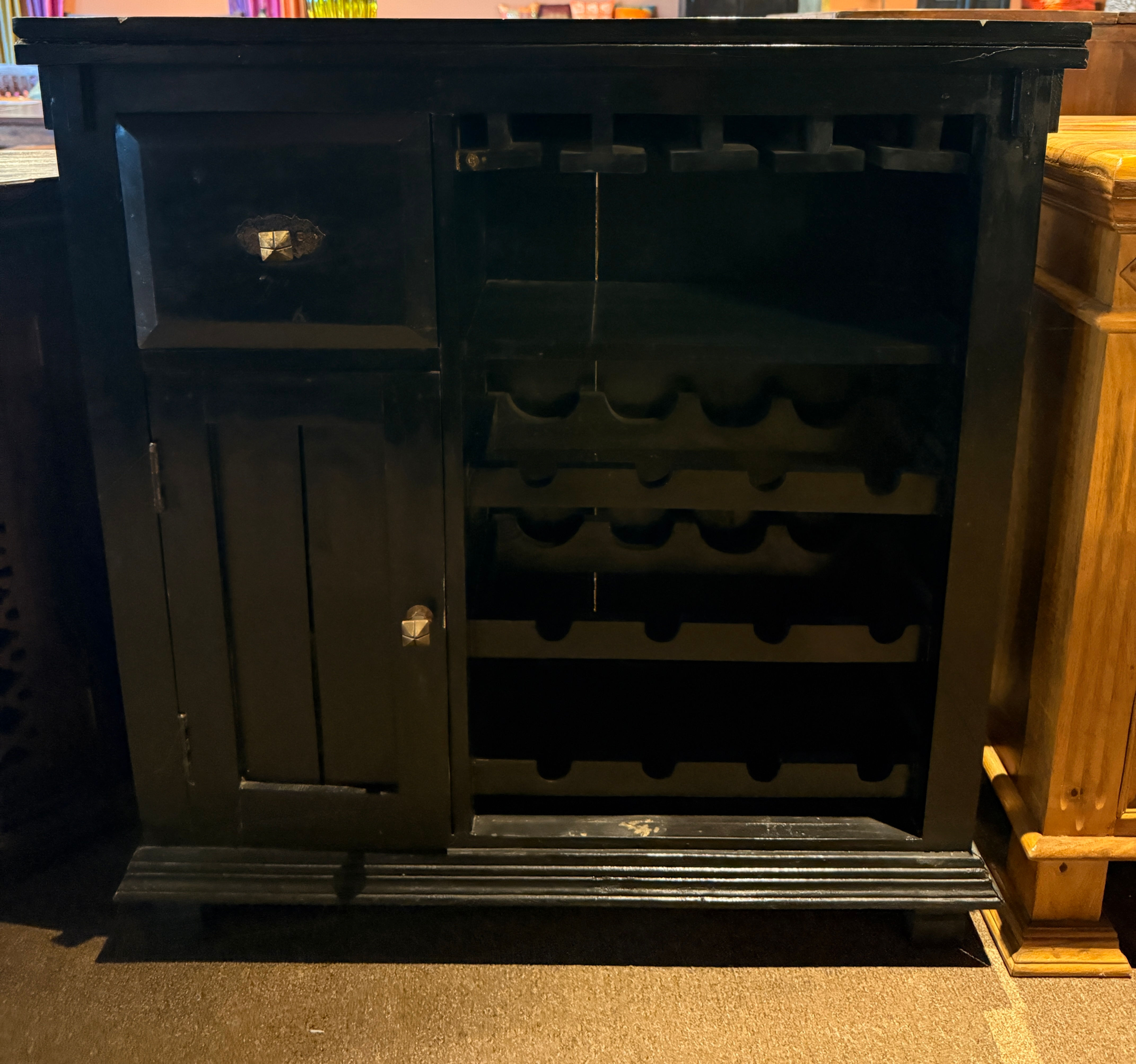 Stylish black wooden wine rack cabinet featuring storage drawers and bottle slots