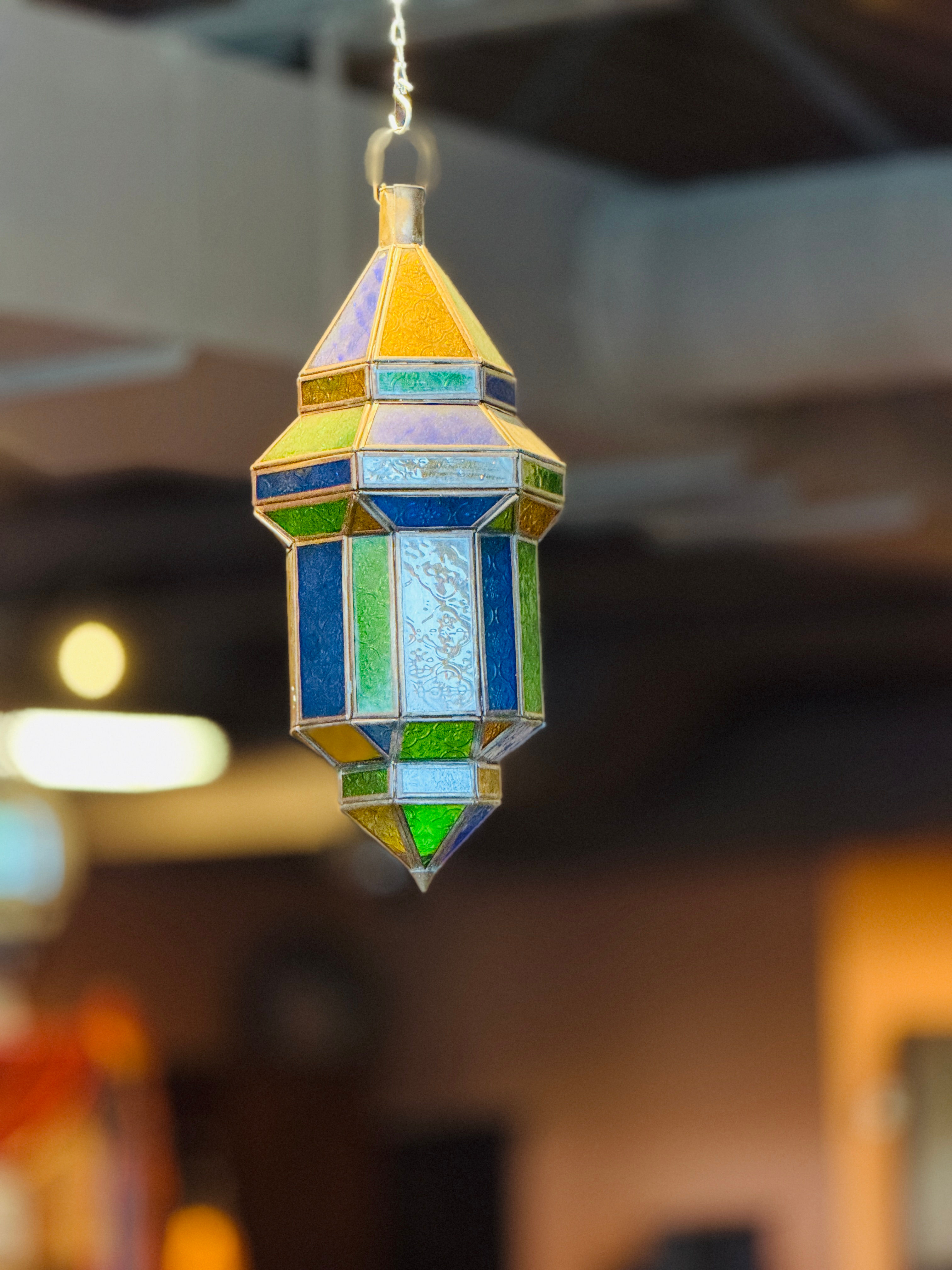 Ornate Moroccan-style hanging lantern with a light antique metal finish