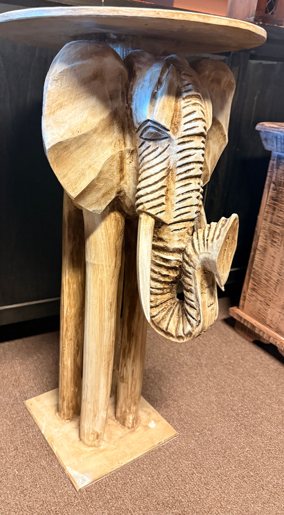 Thumbnail: Hand-carved wooden side table featuring an elephant design with a smooth round top