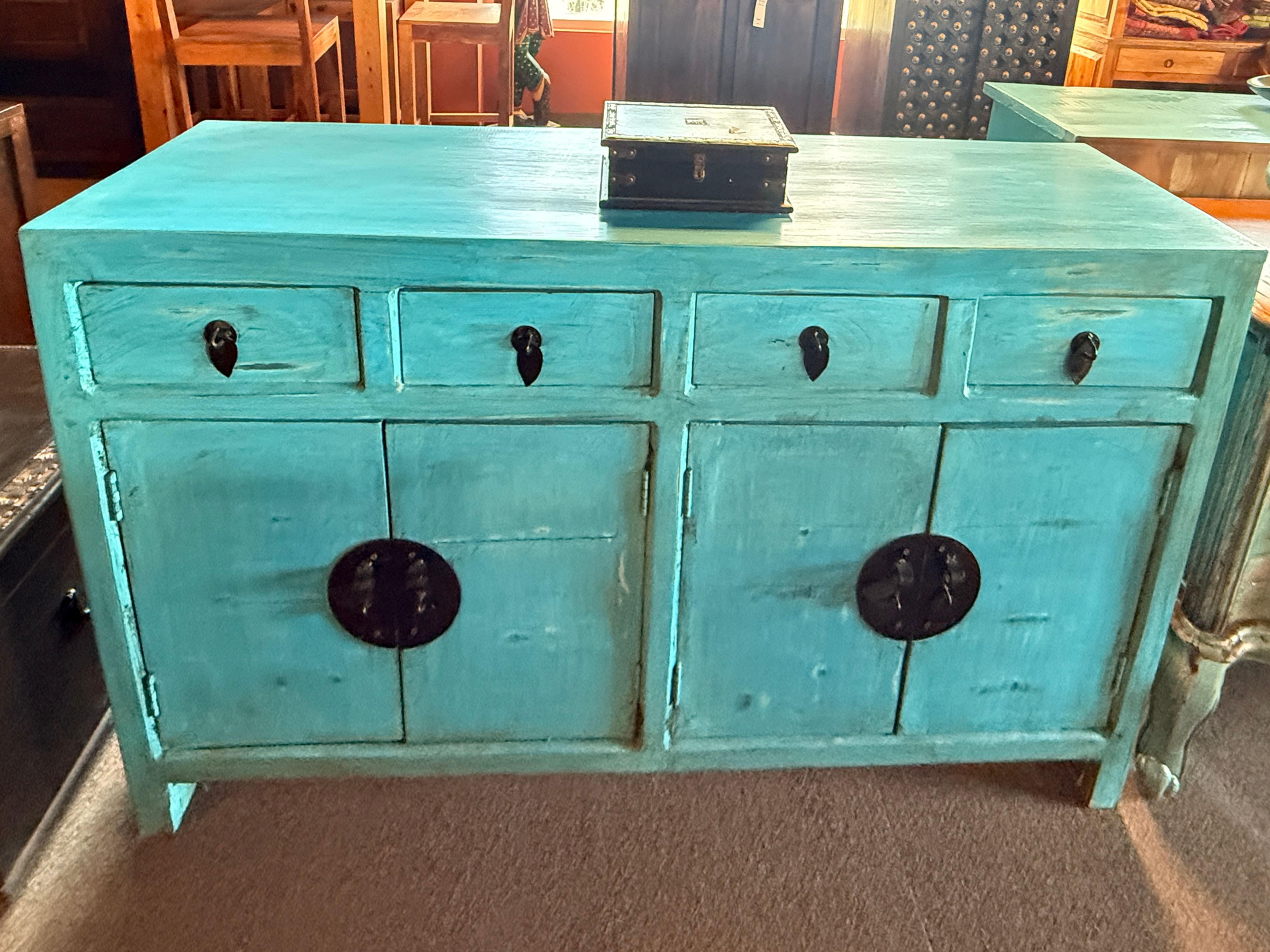Turquoise wooden sideboard featuring black metal accents, three drawers, and two spacious cabinets.