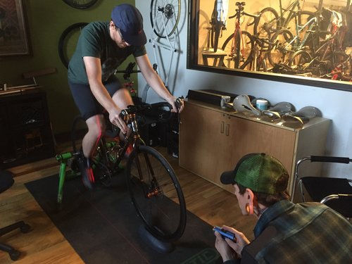 Man using a lazar to check a bike fit