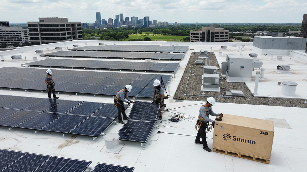 High angle view of a solar panel installation team working on a commercial rooftop