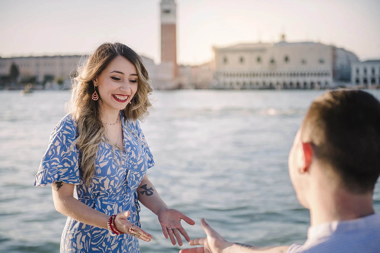 Maria and Barth, hold hands and stare into each other's eyes with affection, the golden hour sunlight softly illuminating their faces.