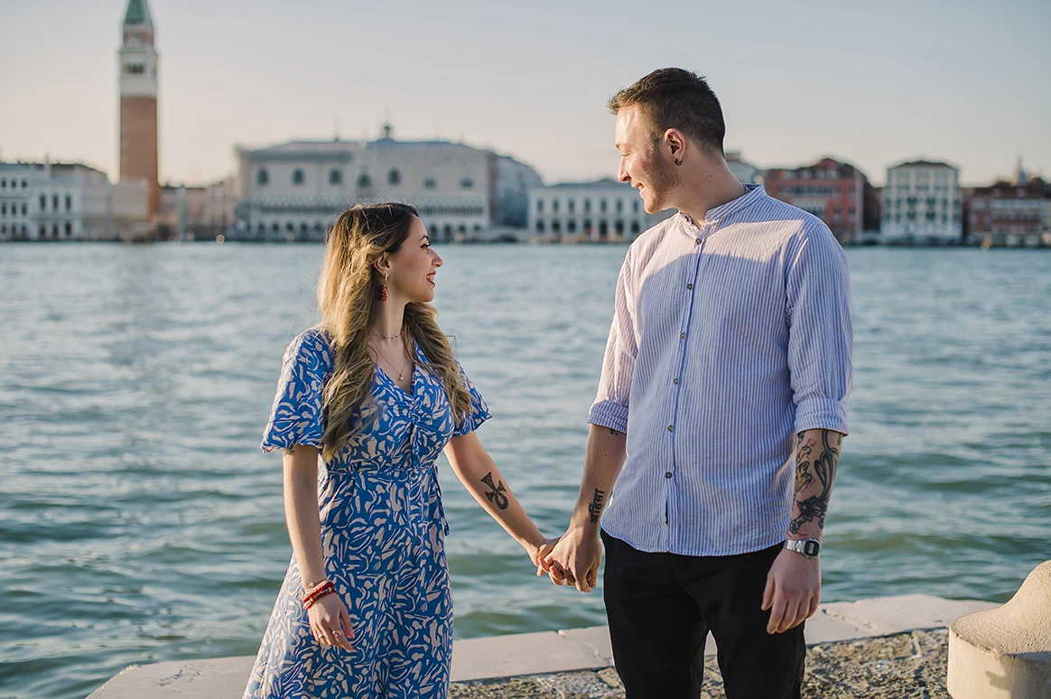 Barth unexpectedly gets down on one knee in San Giorgio Maggiore, presenting an engagement ring to a surprised Maria, whose hands cover a joyful smile
