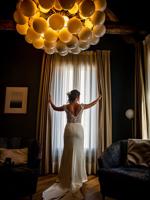bride during his symbolic wedding in venice looking throught a window