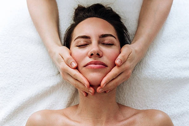 imgi_53_portrait-of-a-woman-getting-a-facial-massage-top-view-close-up
