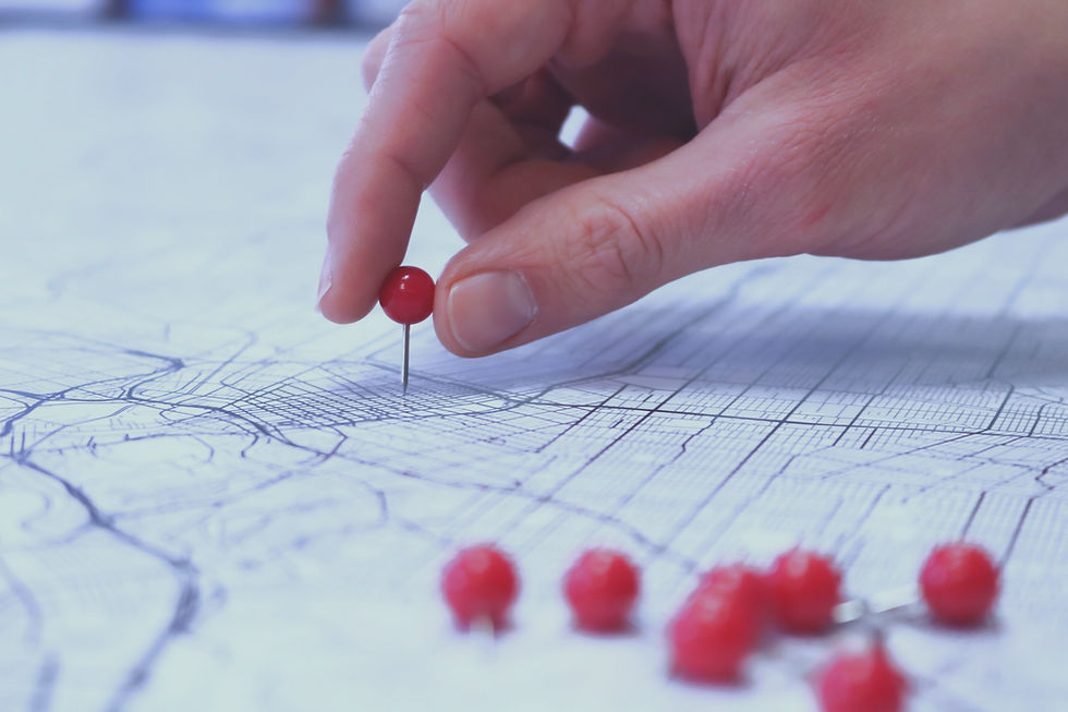 Placing red push pins into city street map_edited_edited.jpg