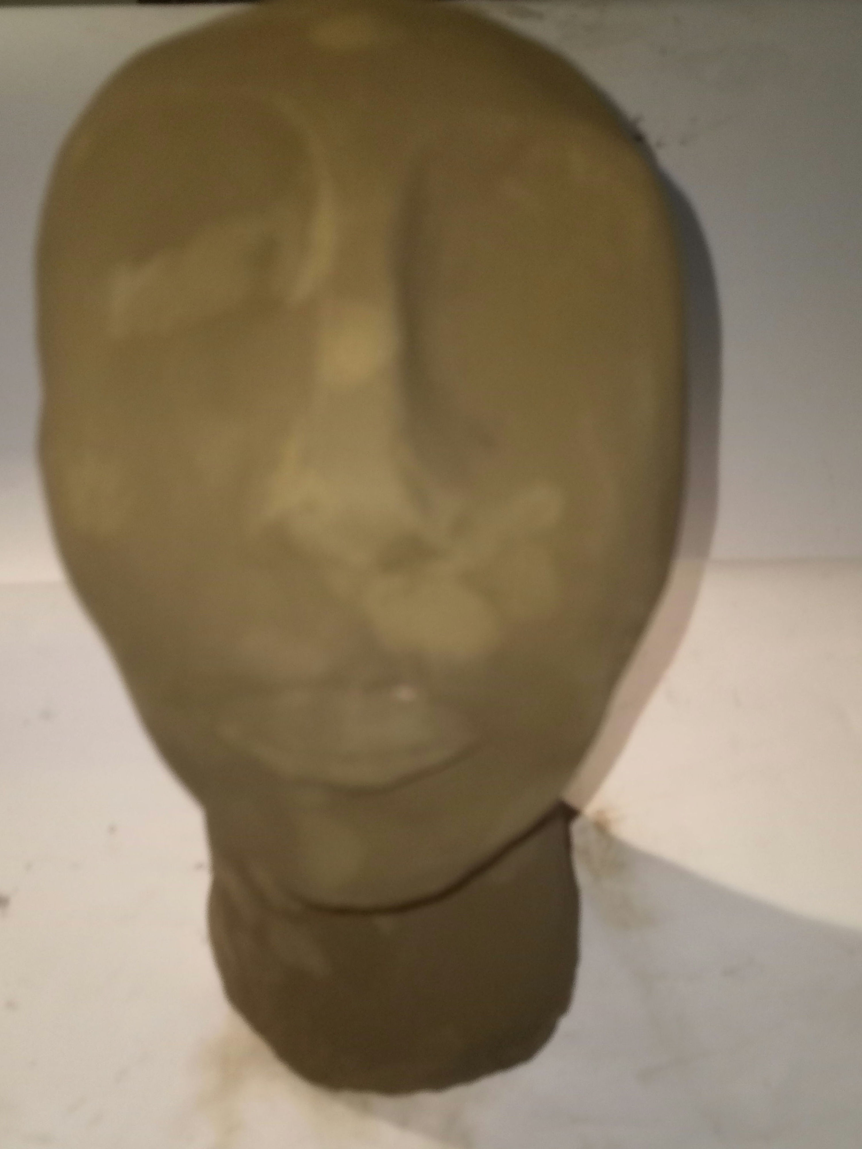 Cara escultura reposa-llibres