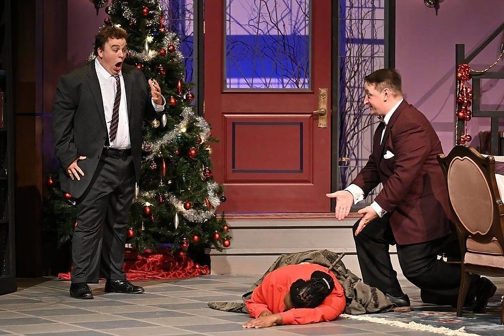 A shocked man sees another man pointing at a woman's body on the floor with a knife in her back.