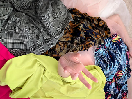 pile of clothes on top of a person