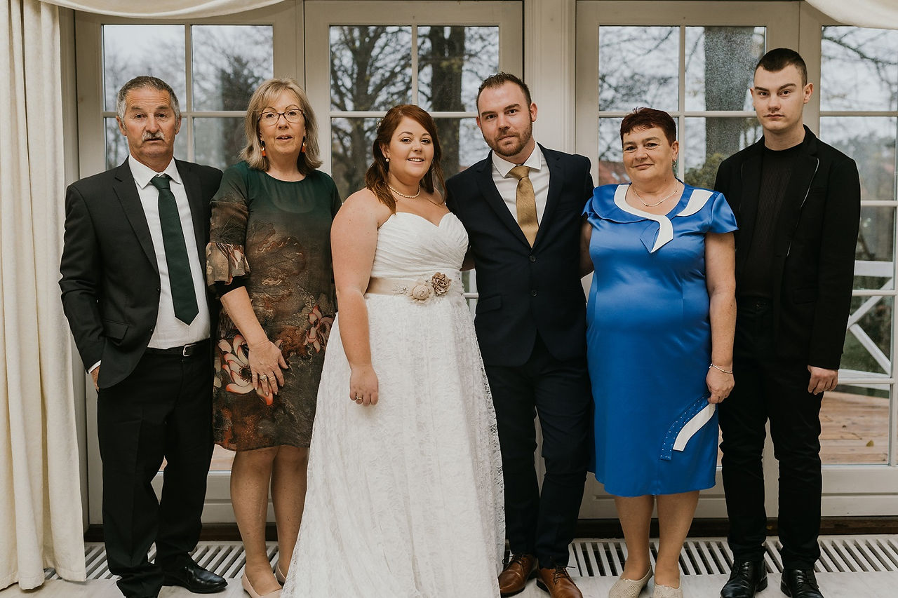 Happy group of the wedding guests posing to the photographer at the wedding in Denmark