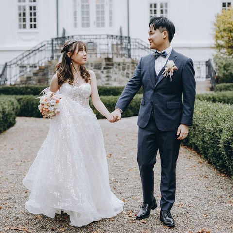 A couple walking on Vindeholme Castle’s grounds, a magical destination for a castle wedding.