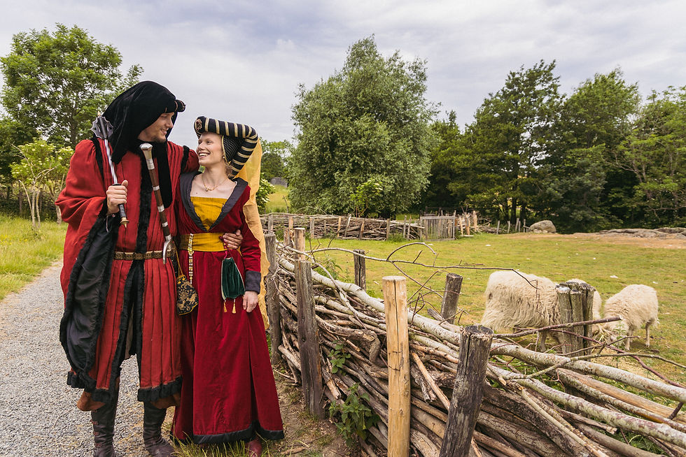 Couple holding hands in front of a medieval castle during their Bornholm wedding