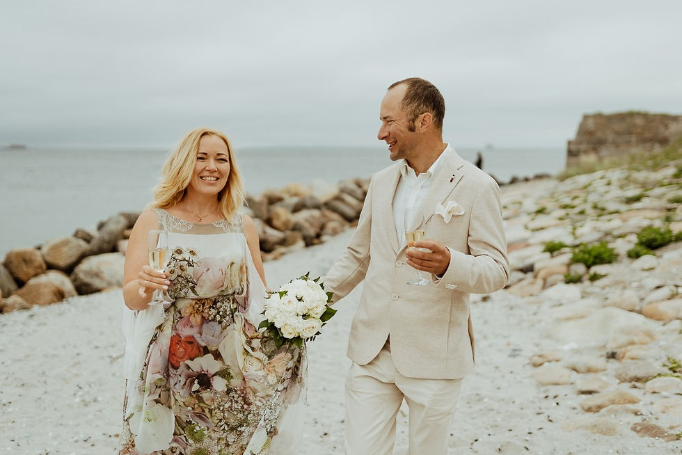 Newlyweds celebrate with champagne their marriage in Denmark