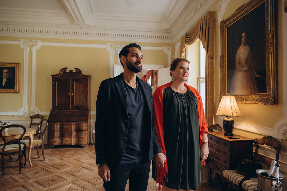 International couple in elegant non-traditional wedding outfits during an intimate castle wedding in Denmark, choosing a personal way to marry abroad.