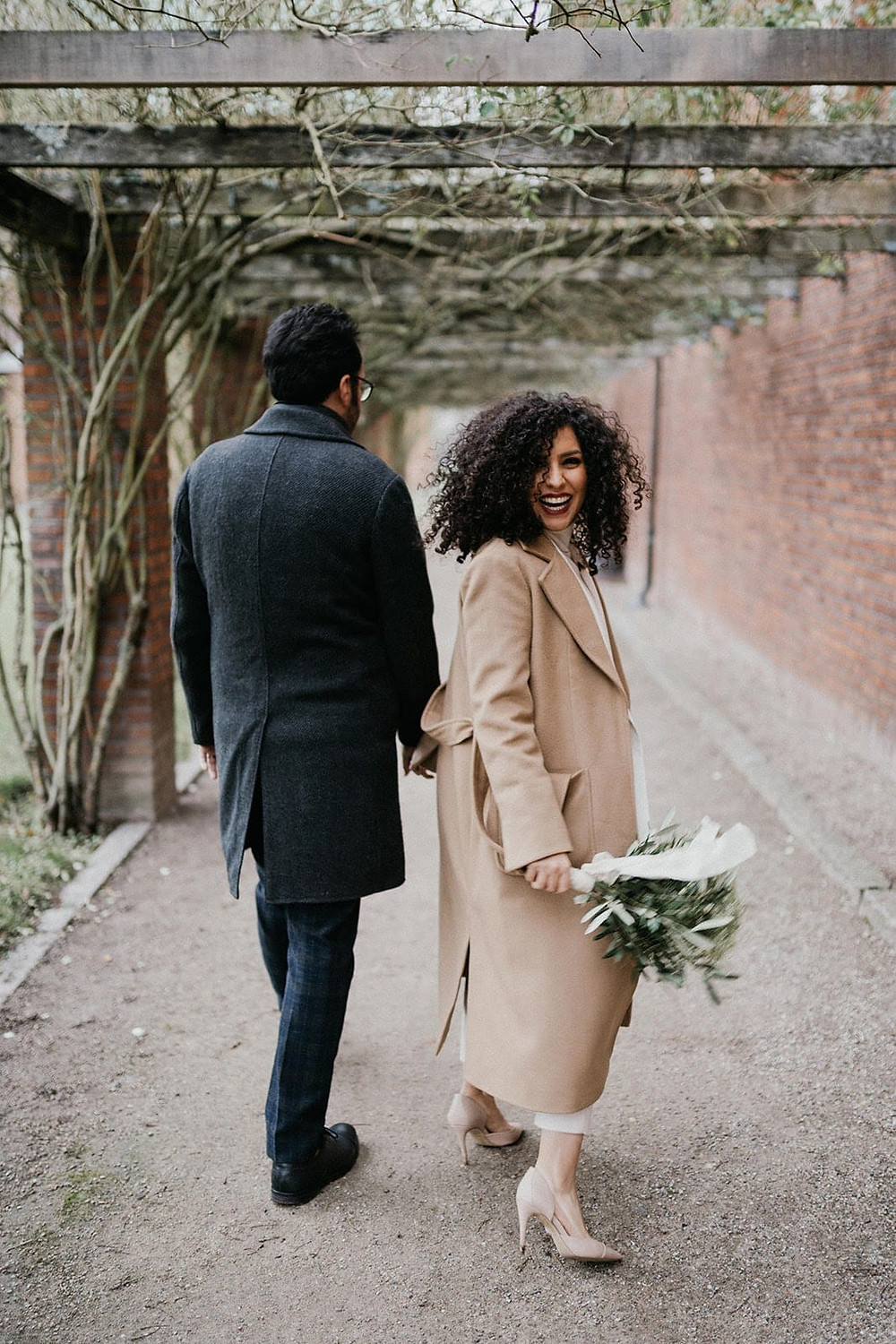 A happy bride looking back and smiling after wedding in Denmark, the easiest country to get married abroad in.