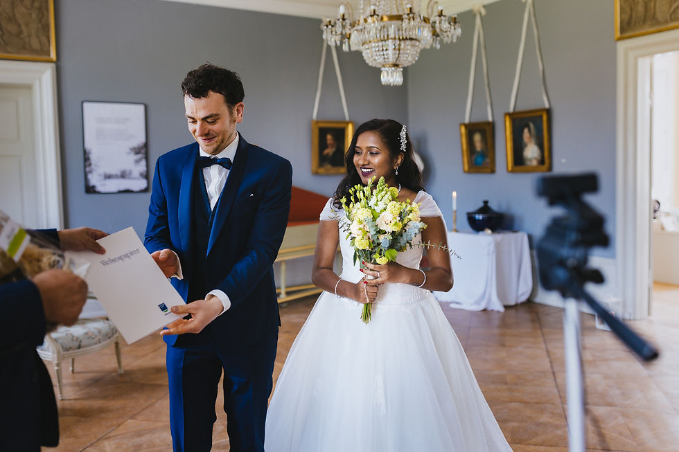 The couple exchanging vows during their legal wedding ceremony at Pederstrup Manor