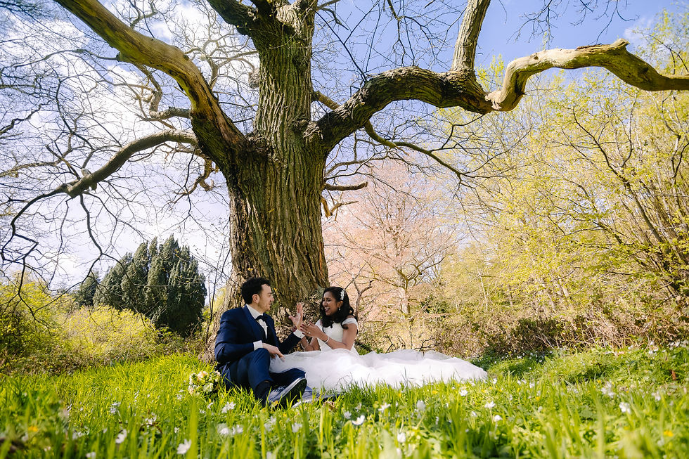 The couple posing outdoors among the mature trees in Pederstrup Manor’s park