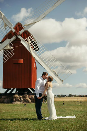 A couple kissing in the front of the mill during their romantic wedding in Denmark