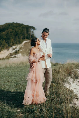A couple toasting at the Møn cliff during their romantic wedding in Denmark