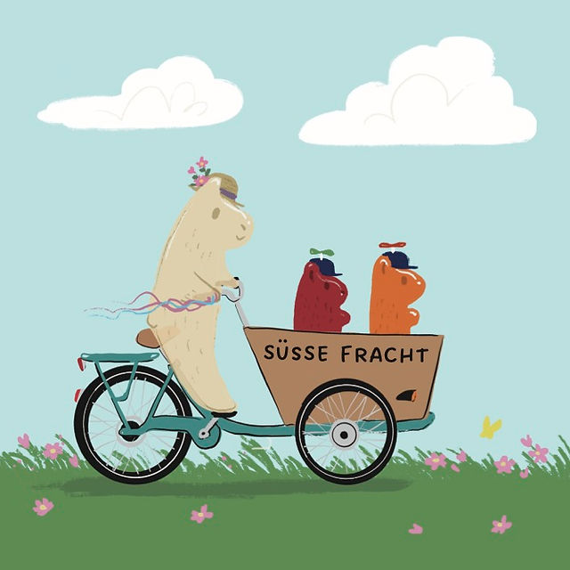 Ein Lastenrad mit drei Gummibärchen fährt über eine Wiese