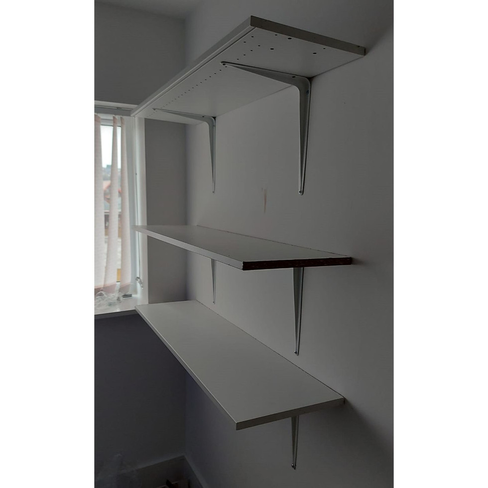 Cut these shelves to size from some sections of wardrobe that were damaged in transit, then affixed to the wall with brackets