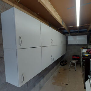 Many cabinets mounted in a garage