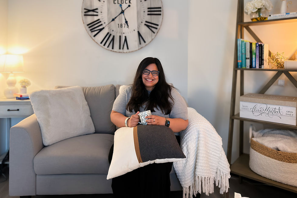 Counsellor in Port Coquitlam, Nivedita Ashok, sitting in a cozy counselling space at Deeply Rooted Counselling