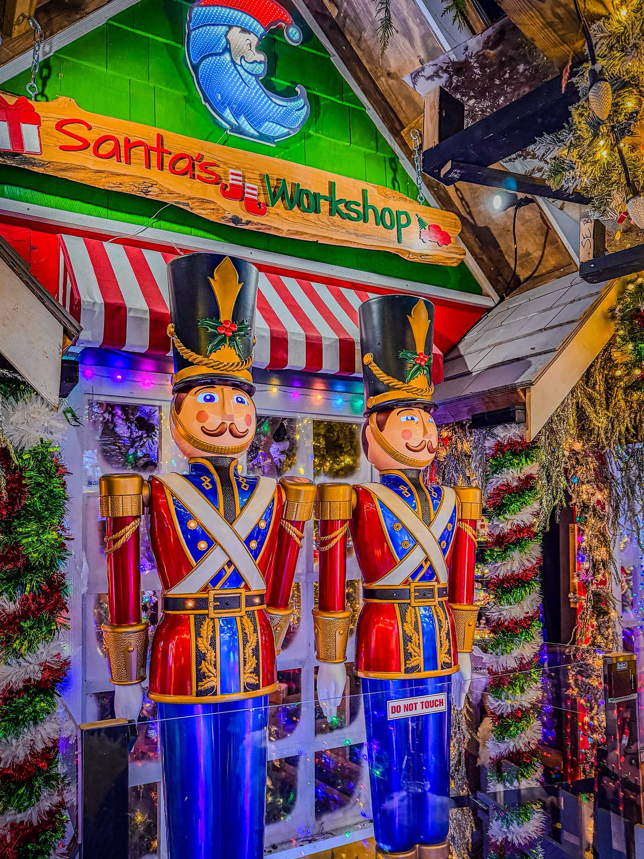 Christmas light display featuring bright holiday decorations, festive characters, and illuminated scenes creating a magical, glowing atmosphere.