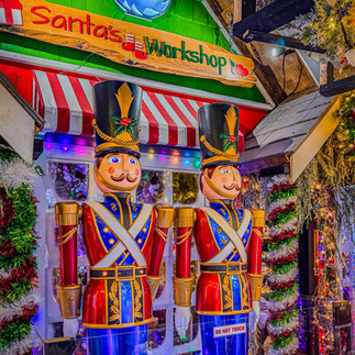 Christmas light display featuring bright holiday decorations, festive characters, and illuminated scenes creating a magical, glowing atmosphere.