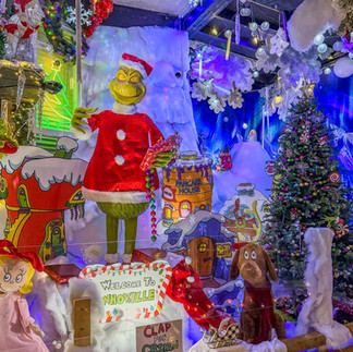 Christmas light display featuring bright holiday decorations, festive characters, and illuminated scenes creating a magical, glowing atmosphere.