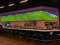 Modern sports bar with soccer match.png