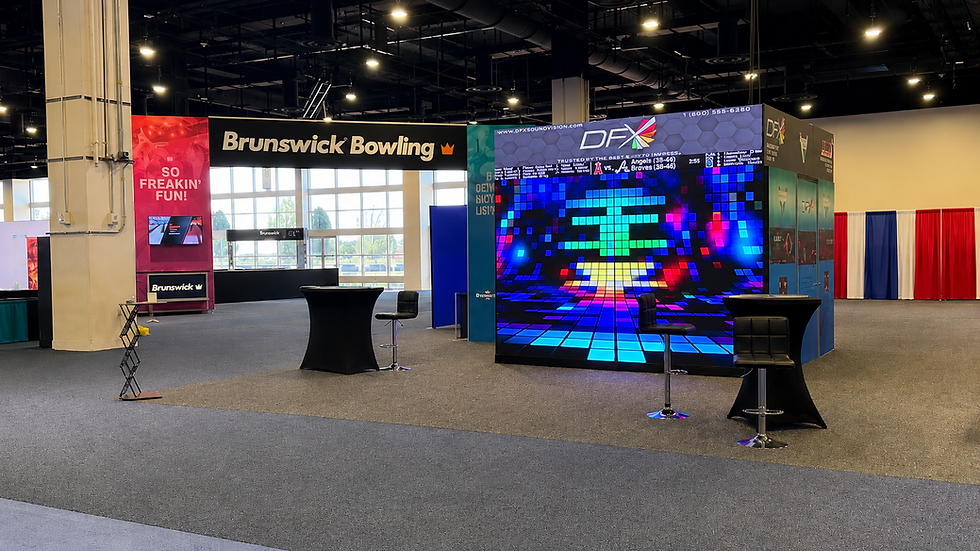Empty bowl expo booth with Brunswick Bowling sign, colorful DFX LED wall, and high-top tables on carpeted floor indoors. DFX Bowl Expo 2026 Booth #612