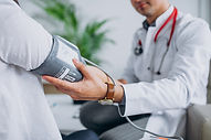young-male-psysician-with-patient-measur