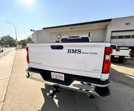 White truck with BMS Heavy Cranes decals