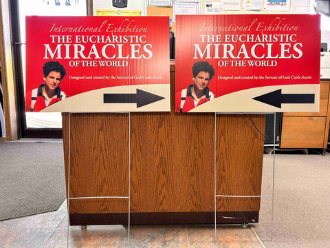 Lawn signs: "International Exhibition The Eucharistic Miracles of the World"