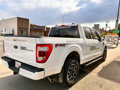 White Ford F-150 truck with BMS decals