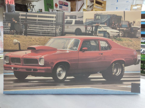 Canva sign Red Pontiac model car, race track background