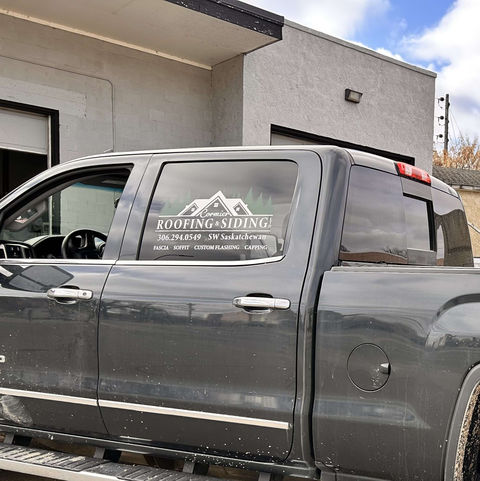 Grey truck with custom decals for Roofing company