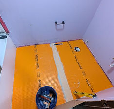 Professional tile installation showing uncoupling membrane preparation before laying tile for a strong, lasting floor