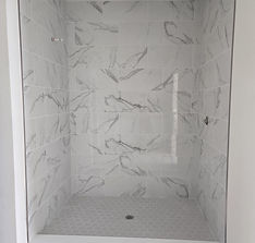 Close-up of professional shower wall tile installation with clean grout lines and precise spacing