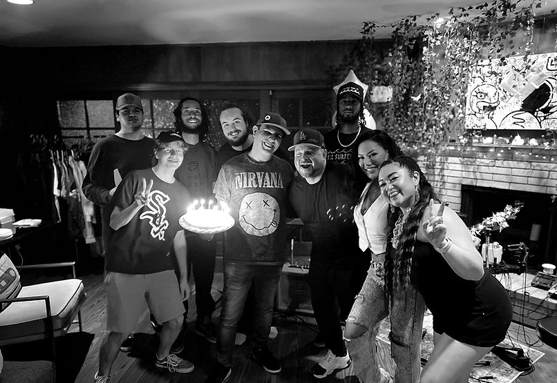 Music Patch family gathered around the Tiny-Desk Rehearsal area at The Music Patch Recording Studio in Burbank, California