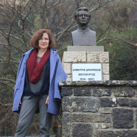 Valia Dragataki-Koronidi with her father's bronze bust in his hometown of Platanousa, Epirus. Photo supplied by the Dragatakis Archive and Valia Dragataki-Koronidi.