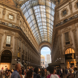 Galleria Vittorio Emanuele II di Milano interior upscale shops and glass ceiling.
