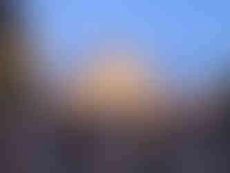 Night time at the Milan Duomo, many people walking along the piazza.