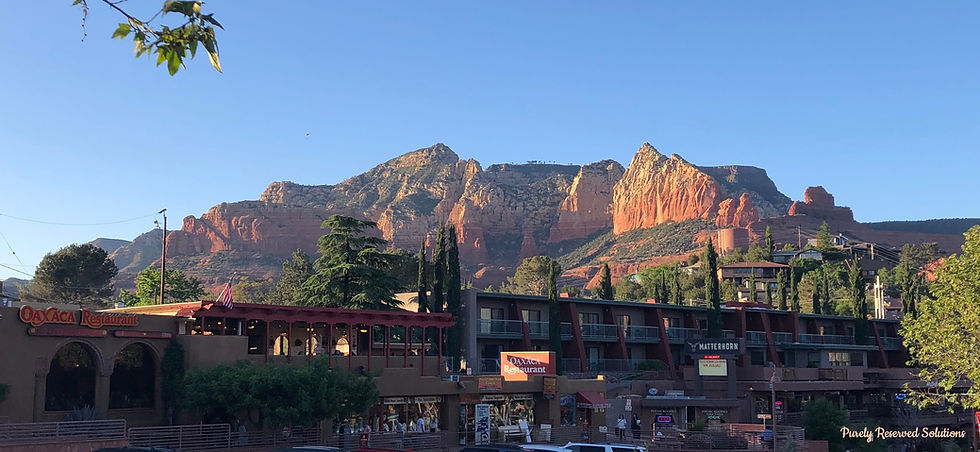 Street view of Uptown Sedona restaurants/shops with red rock mountains in background