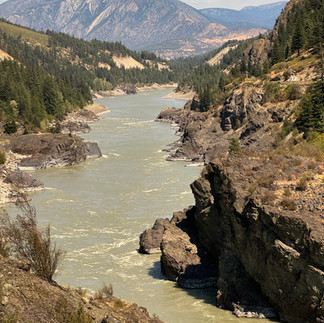 River winding amongst rocks and mountains in the distance.
