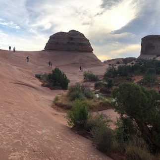Rock formations en route to Delicate Arch under an overcast sky.